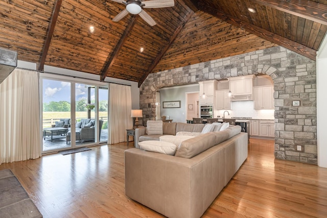 3013 Berry Patch Trl, Rockvale, TN 37153 - living area with high vaulted ceiling, wood ceiling with exposed beams, light wood-style flooring, a ceiling fan, and arched walkways
