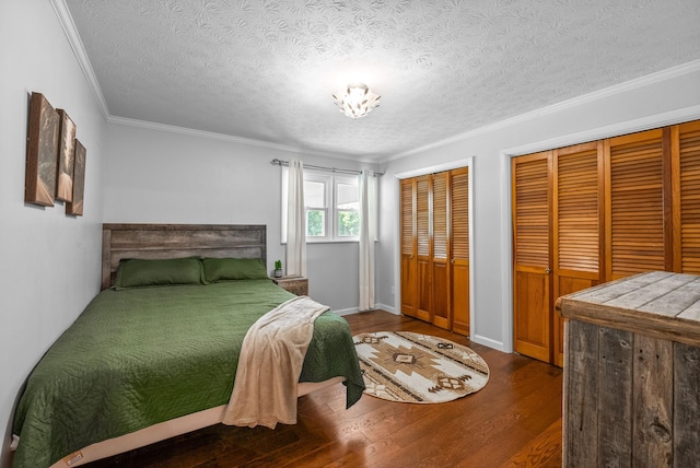 6085 Blue Springs Rd, Cadiz, KY 42211 - bedroom with two closets, wood finished floors, a textured ceiling, crown molding, and baseboards