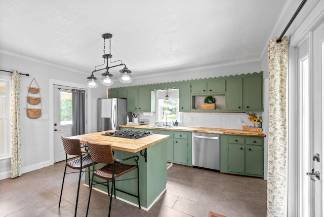6085 Blue Springs Rd, Cadiz, KY 42211 - kitchen featuring green cabinetry, stainless steel appliances, butcher block countertops, ornamental molding, and a textured ceiling