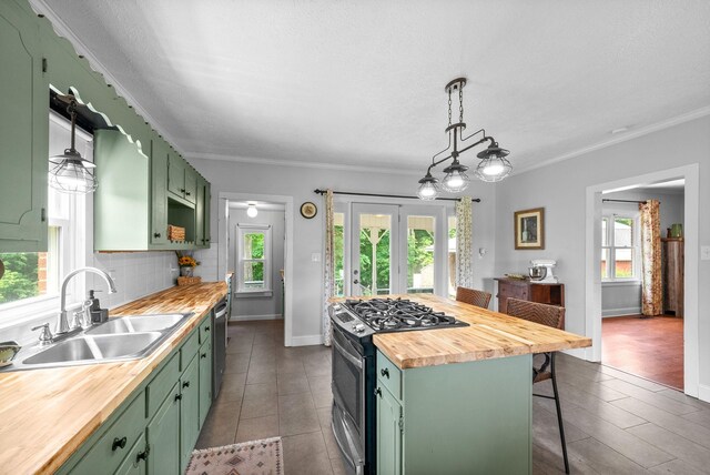 6085 Blue Springs Rd, Cadiz, KY 42211 - kitchen with green cabinetry, butcher block counters, appliances with stainless steel finishes, a sink, and crown molding