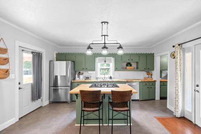 6085 Blue Springs Rd, Cadiz, KY 42211 - kitchen featuring appliances with stainless steel finishes, green cabinetry, butcher block counters, a sink, and ornamental molding