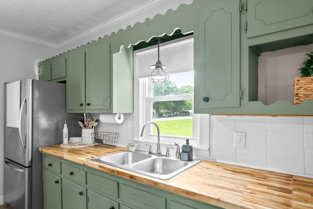 6085 Blue Springs Rd, Cadiz, KY 42211 - kitchen featuring wooden counters, a sink, green cabinetry, ornamental molding, and freestanding refrigerator