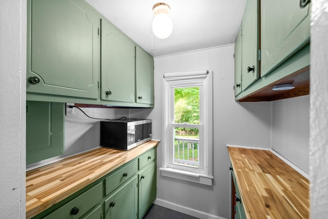 6085 Blue Springs Rd, Cadiz, KY 42211 - kitchen featuring green cabinetry, wood counters, and baseboards