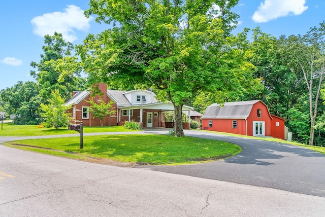 6085 Blue Springs Rd, Cadiz, KY 42211 - view of front of house featuring curved driveway, a front yard, brick siding, and a chimney