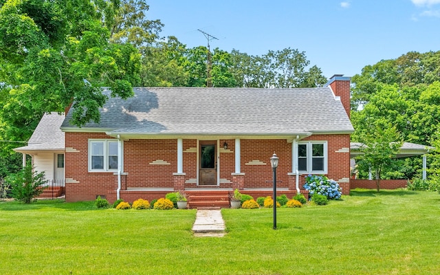 6085 Blue Springs Rd, Cadiz, KY 42211 - view of front of home featuring a chimney, a front lawn, brick siding, and a shingled roof