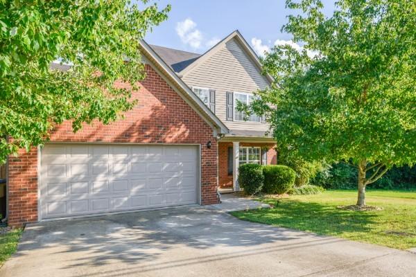 5035 Preserve Blvd, Antioch, TN 37013 - traditional-style house with a garage, brick siding, concrete driveway, and a front yard