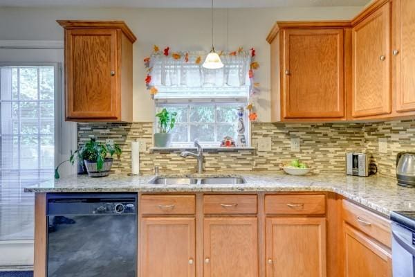 5035 Preserve Blvd, Antioch, TN 37013 - kitchen featuring dishwasher, a sink, backsplash, and light stone counters