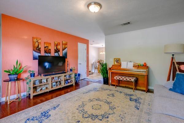 5035 Preserve Blvd, Antioch, TN 37013 - living area with wood finished floors, baseboards, and a chandelier