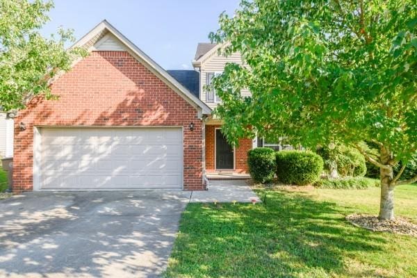5035 Preserve Blvd, Antioch, TN 37013 - view of front of house featuring a garage, driveway, brick siding, and a front lawn