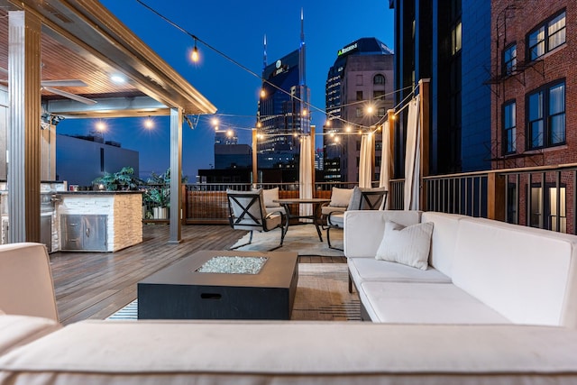 207 3rd Ave N Unit 602, Nashville, TN 37201 - patio at night with an outdoor living space with a fire pit and a wooden deck