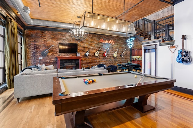 207 3rd Ave N Unit 602, Nashville, TN 37201 - rec room with wood finished floors, brick wall, billiards, baseboards, and a brick fireplace