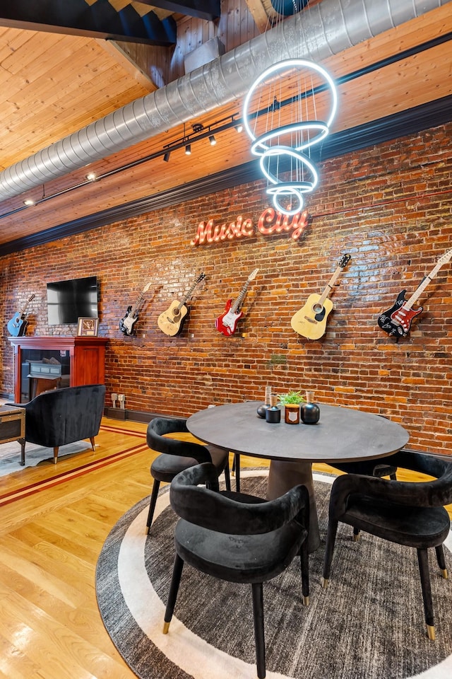 207 3rd Ave N Unit 602, Nashville, TN 37201 - dining space with brick wall, wood finished floors, and a chandelier