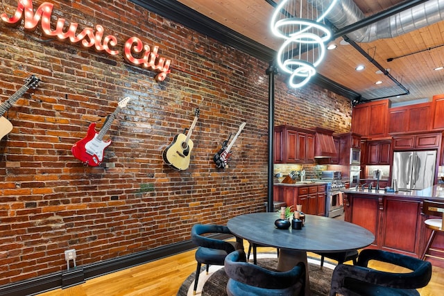 207 3rd Ave N Unit 602, Nashville, TN 37201 - dining space with wood finished floors, brick wall, and a chandelier