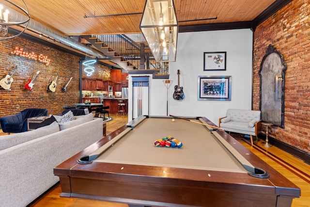 207 3rd Ave N Unit 602, Nashville, TN 37201 - rec room featuring brick wall, wood finished floors, pool table, baseboards, and ornamental molding