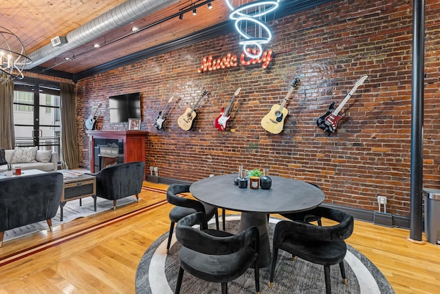 207 3rd Ave N Unit 602, Nashville, TN 37201 - dining space featuring wood finished floors, brick wall, and a chandelier