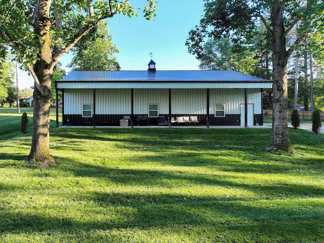 2207 Oakwood Ct, Franklin, TN 37064 - back of house with board and batten siding, a pole building, a yard, an outdoor structure, and metal roof