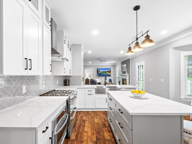 2207 Oakwood Ct, Franklin, TN 37064 - kitchen featuring a sink, wall chimney range hood, double oven range, a peninsula, and glass insert cabinets