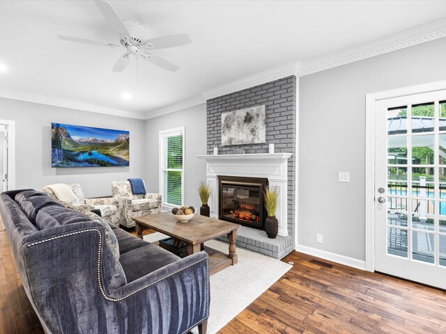 2207 Oakwood Ct, Franklin, TN 37064 - living area featuring wood finished floors, ornamental molding, a fireplace, baseboards, and a ceiling fan