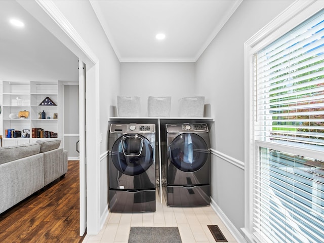 2207 Oakwood Ct, Franklin, TN 37064 - laundry area featuring washer and dryer, crown molding, baseboards, and wood finished floors