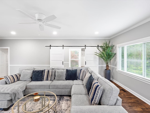 2207 Oakwood Ct, Franklin, TN 37064 - living room featuring a barn door, dark wood-style flooring, recessed lighting, ceiling fan, and crown molding
