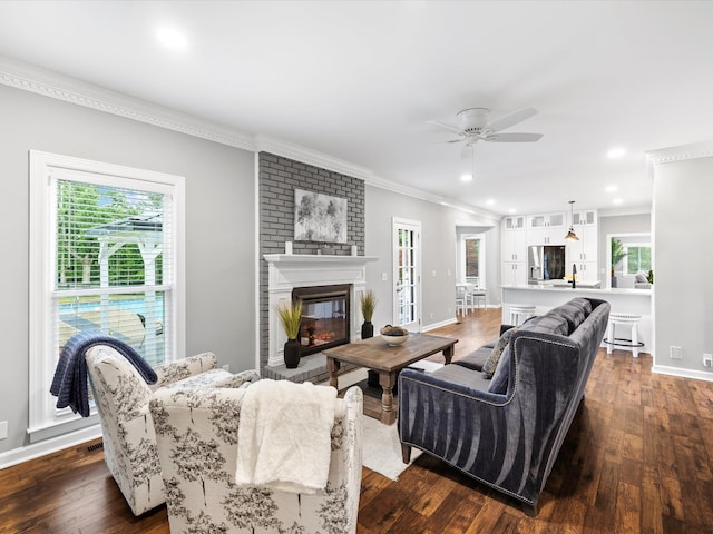 2207 Oakwood Ct, Franklin, TN 37064 - living room with crown molding, a ceiling fan, dark wood-style flooring, a fireplace, and baseboards