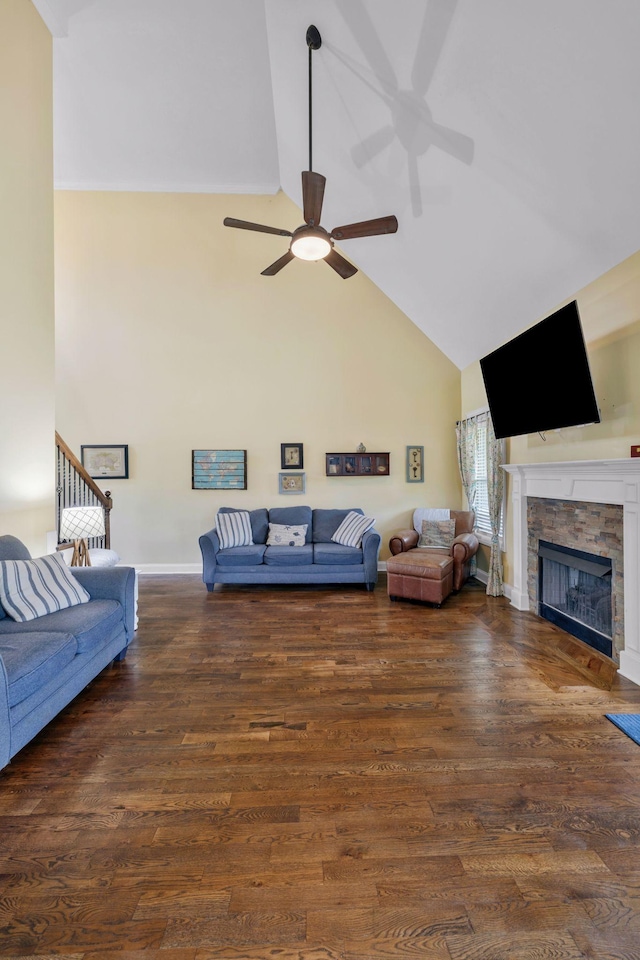 2122 Slater Dr, Murfreesboro, TN 37128 - living room featuring a stone fireplace, a ceiling fan, high vaulted ceiling, wood finished floors, and baseboards