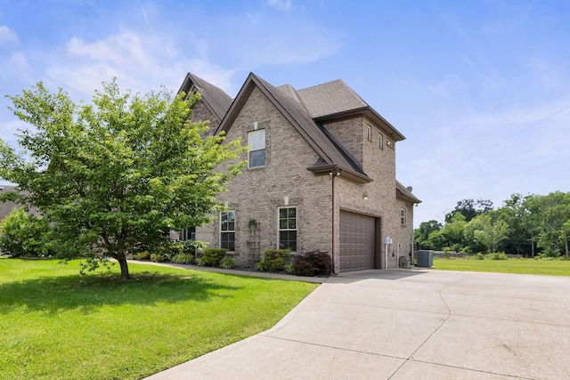 2122 Slater Dr, Murfreesboro, TN 37128 - view of front of property featuring central AC, a garage, driveway, brick siding, and a front lawn