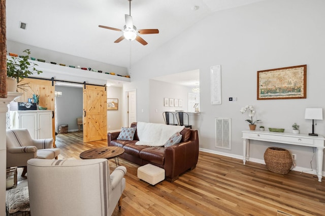 3207 Gardendale Dr, Franklin, TN 37064 - living area featuring a ceiling fan, a barn door, light wood-style floors, high vaulted ceiling, and baseboards