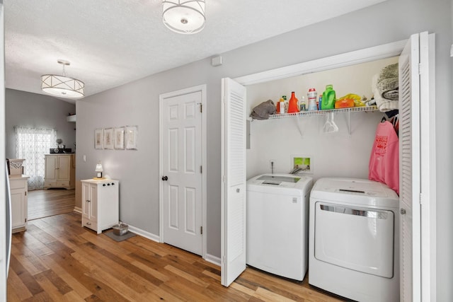 3207 Gardendale Dr, Franklin, TN 37064 - laundry room with independent washer and dryer, light wood-style floors, a textured ceiling, and baseboards