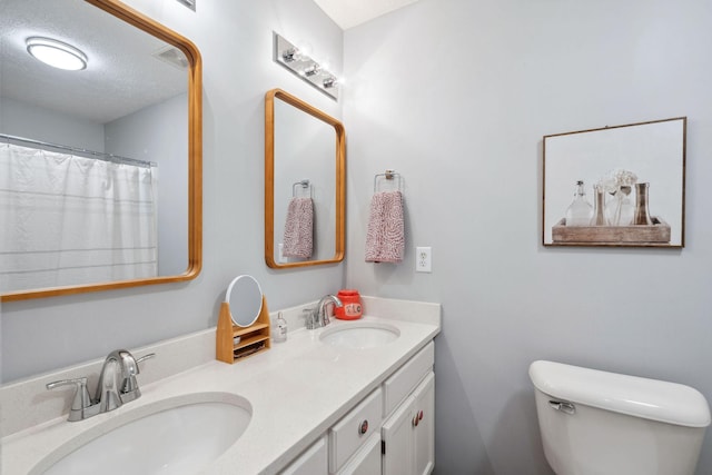 3207 Gardendale Dr, Franklin, TN 37064 - bathroom featuring double vanity, toilet, and a textured ceiling
