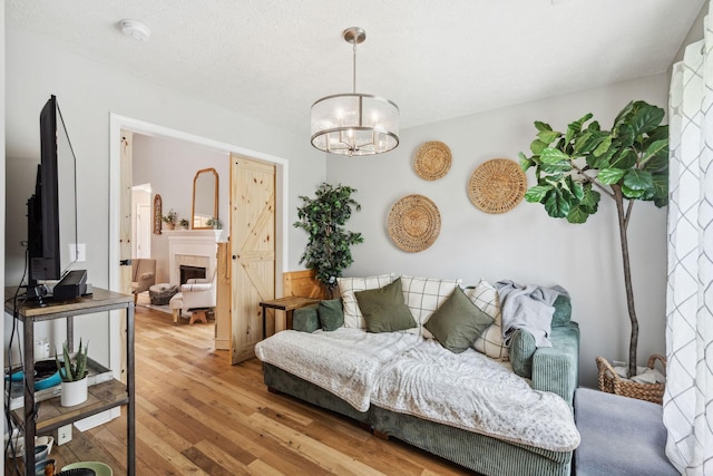 3207 Gardendale Dr, Franklin, TN 37064 - living room featuring wood-type flooring, a chandelier, and a tile fireplace