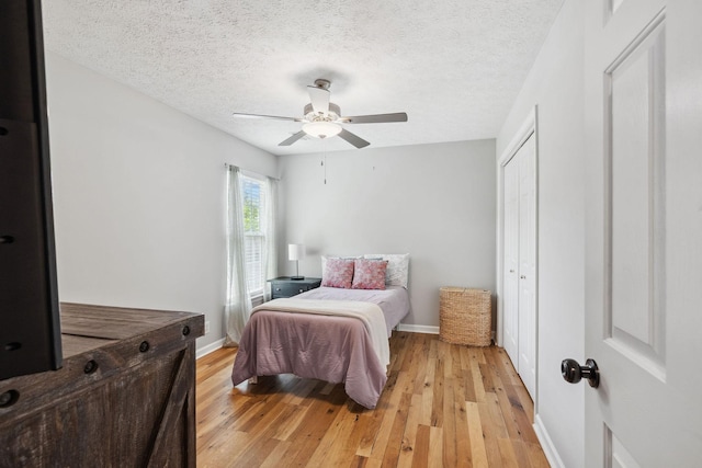 3207 Gardendale Dr, Franklin, TN 37064 - bedroom featuring light wood-type flooring, a closet, baseboards, and a textured ceiling