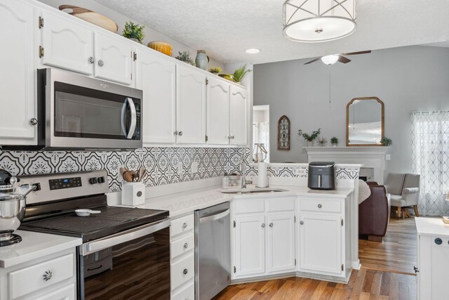 3207 Gardendale Dr, Franklin, TN 37064 - kitchen with appliances with stainless steel finishes, ceiling fan, white cabinetry, backsplash, and a textured ceiling