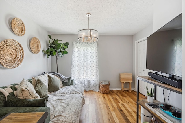 3207 Gardendale Dr, Franklin, TN 37064 - living room with hardwood / wood-style flooring, a chandelier, a textured ceiling, and baseboards