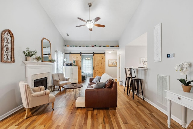 3207 Gardendale Dr, Franklin, TN 37064 - living room with ceiling fan, wood finished floors, high vaulted ceiling, a fireplace, and baseboards