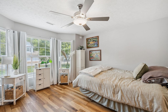 3207 Gardendale Dr, Franklin, TN 37064 - bedroom featuring a textured ceiling, light wood-type flooring, and ceiling fan