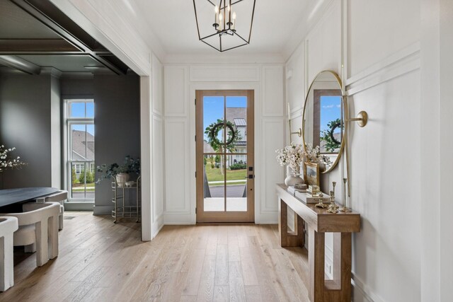 2764 Otterham Dr, Thompsons Station, TN 37179 - entrance foyer featuring light wood-style flooring, a chandelier, and a decorative wall