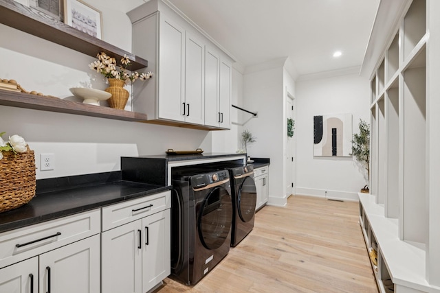 2764 Otterham Dr, Thompsons Station, TN 37179 - laundry room featuring washing machine and clothes dryer, cabinet space, light wood-style flooring, crown molding, and recessed lighting