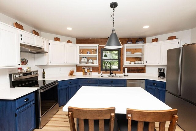 652 Northup Rd, Portland, TN 37148 - kitchen with stainless steel appliances, open shelves, blue cabinets, under cabinet range hood, and a sink