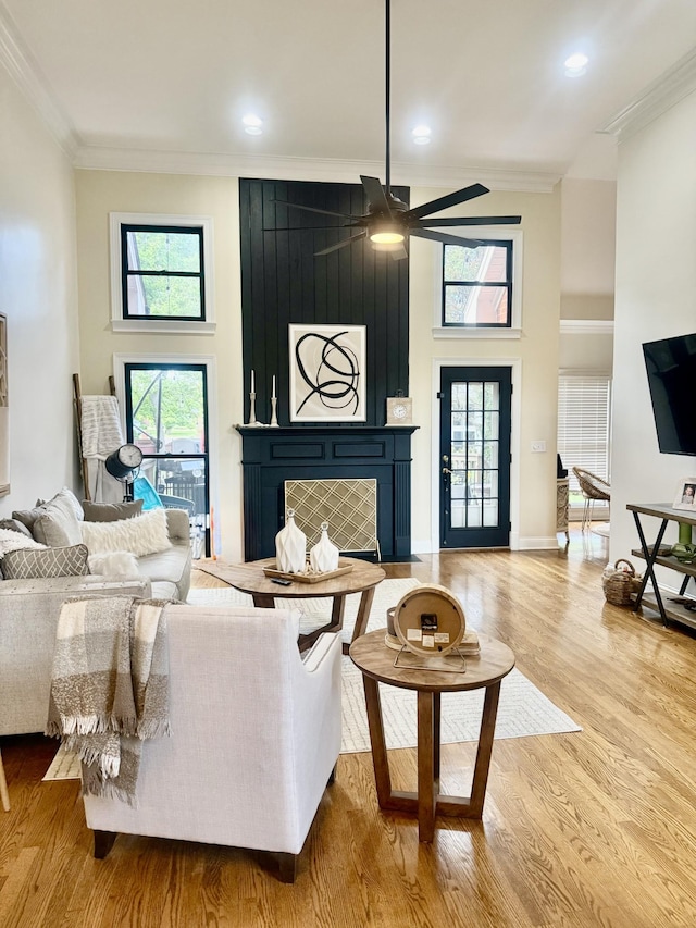 2815 Anglo Ct, Murfreesboro, TN 37129 - living area with crown molding, a ceiling fan, wood finished floors, a fireplace, and a towering ceiling