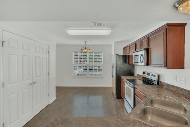 2013 Shaylin Loop, Antioch, TN 37013 - kitchen with appliances with stainless steel finishes, a sink, a chandelier, and dark countertops