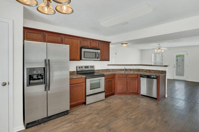 2013 Shaylin Loop, Antioch, TN 37013 - kitchen with appliances with stainless steel finishes, a peninsula, dark wood-style floors, a sink, and ceiling fan
