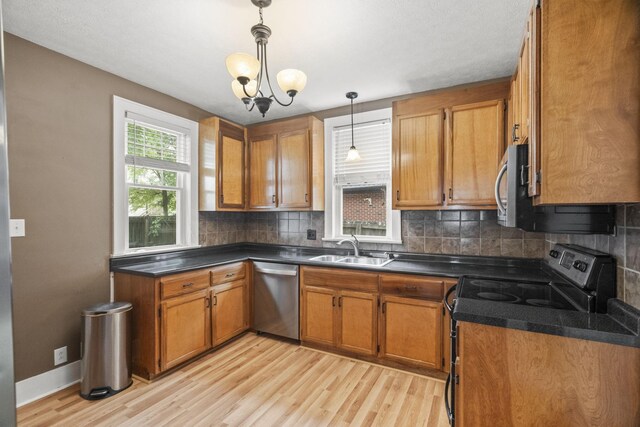 400 Connell St, Springfield, TN 37172 - kitchen featuring stainless steel appliances, a sink, light wood finished floors, and brown cabinets