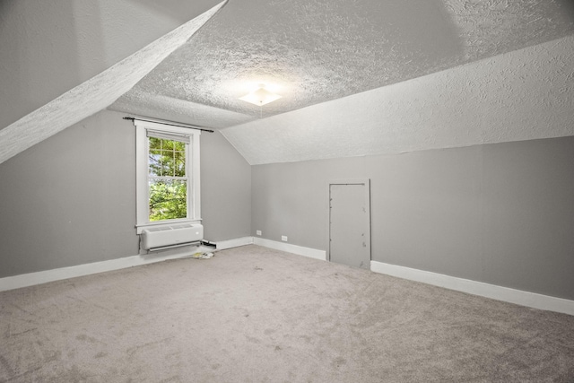 400 Connell St, Springfield, TN 37172 - additional living space with a textured ceiling, baseboards, carpet flooring, lofted ceiling, and an AC wall unit