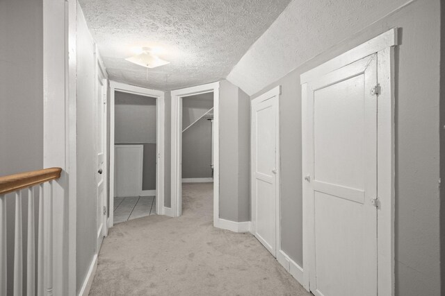 400 Connell St, Springfield, TN 37172 - corridor featuring light colored carpet, a textured ceiling, vaulted ceiling, and baseboards