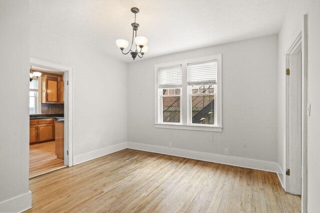 400 Connell St, Springfield, TN 37172 - unfurnished dining area with a chandelier, plenty of natural light, baseboards, and light wood-style flooring