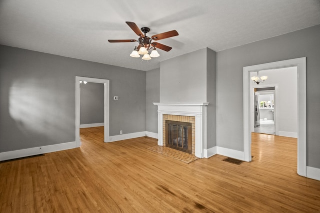 400 Connell St, Springfield, TN 37172 - unfurnished living room with light wood-style floors, a brick fireplace, a ceiling fan, and baseboards