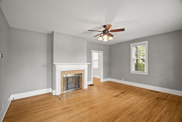 400 Connell St, Springfield, TN 37172 - unfurnished living room with light wood-type flooring, a ceiling fan, a brick fireplace, and baseboards