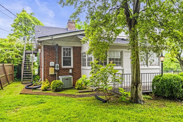400 Connell St, Springfield, TN 37172 - back of property featuring cooling unit, brick siding, a chimney, a shingled roof, and stairway