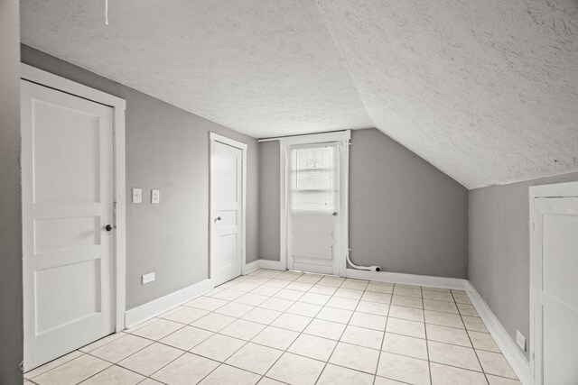 400 Connell St, Springfield, TN 37172 - bonus room featuring a textured ceiling, light tile patterned floors, vaulted ceiling, and baseboards